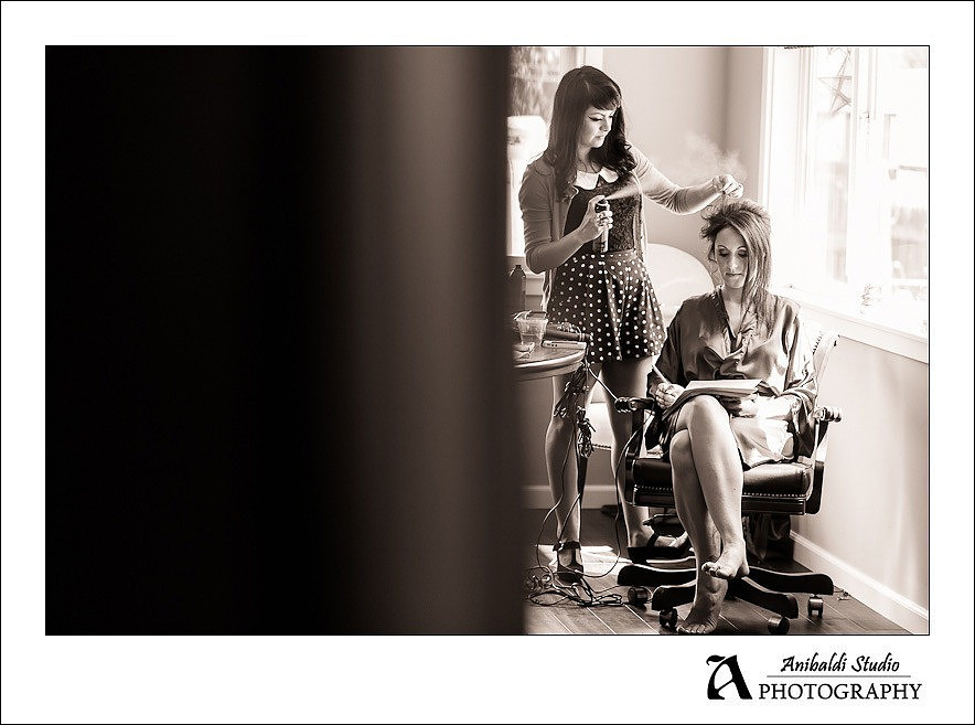 bride writting vows while getting hair done